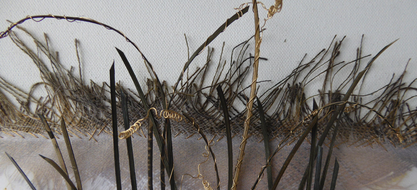 Wrapped canes, grasses and frayed linen edge